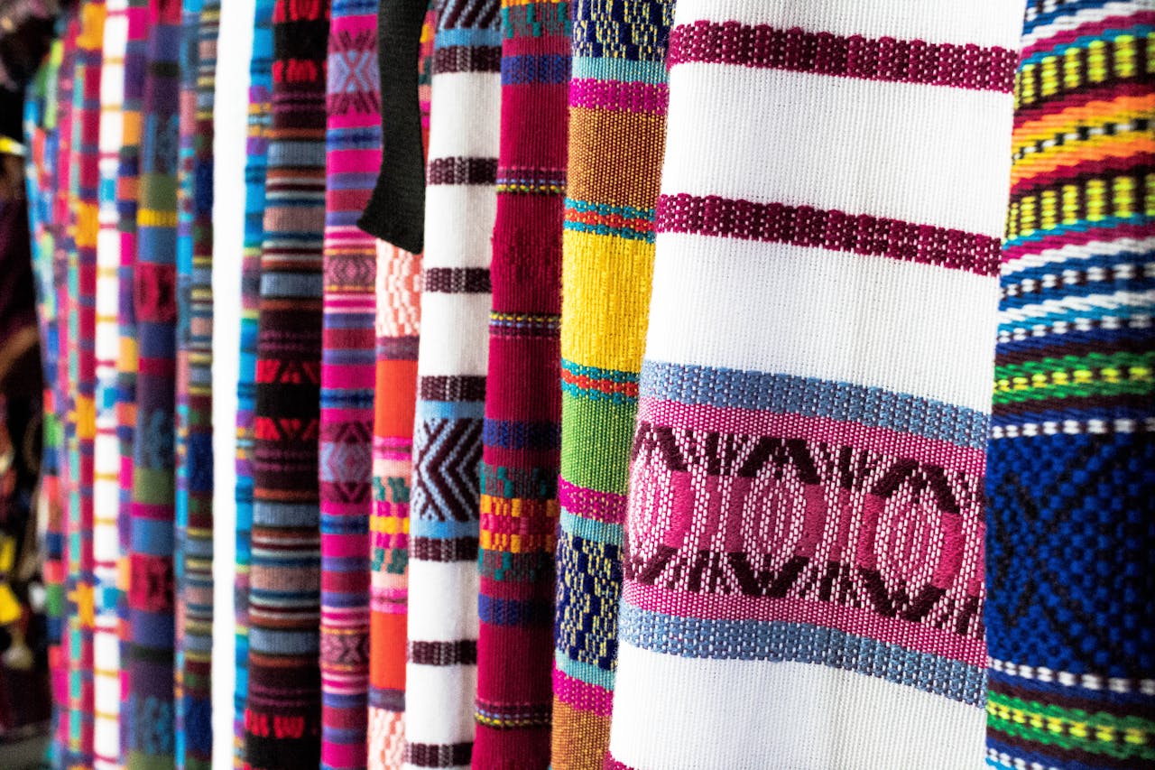 Vibrant woven fabrics showcasing traditional patterns in Antigua Guatemala market.